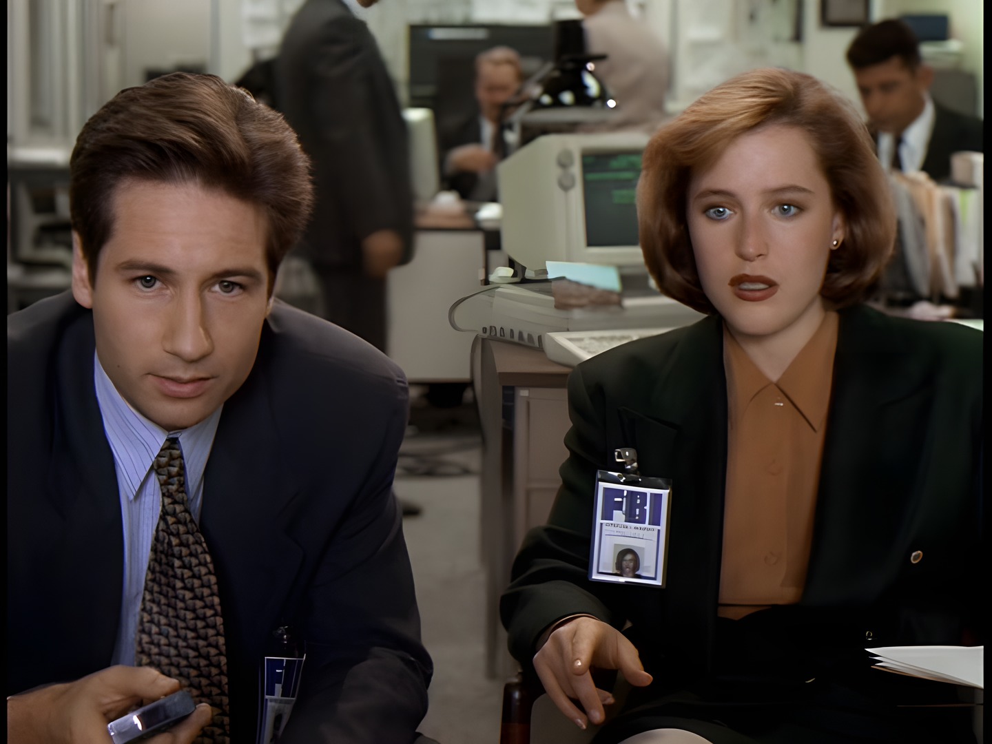 Mulder and Scully at a desk in the FBI office